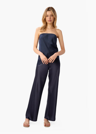 Cami NYC Bristol Mid Rise Pant Dark Wash. Model is posing in the product and image is shot on white background. 