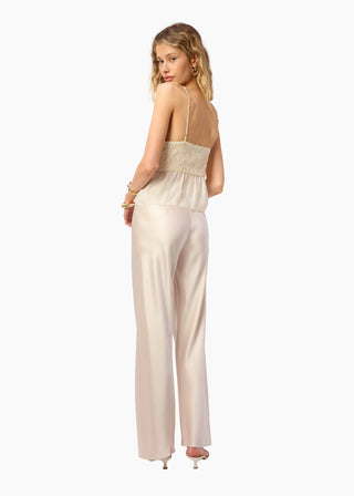 Cami NYC Bristol Mid Rise Pant Oat. Model is turning towards the camera and is wearing the pants. Image shot on white background. 