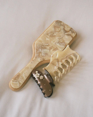 Emi Jay Bamboo Paddle Brush in Chantilly. Product is shot with other Emi Jay products. 