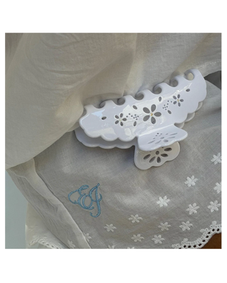 Emi Jay Big Effing Claw Clip in Blanc Fleur Eyelet. Emi Jay clip is shown attached to a peice of clothing. 