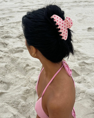 Emi Jay Big Effing Claw Clip in Blush Polka Dot. Model wearing hair clip on the beach.