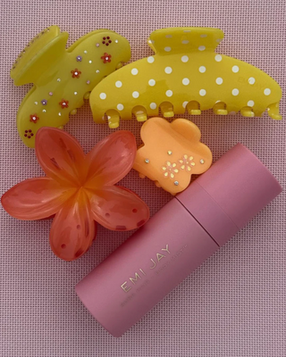 Emi Jay Big Super Bloom Clip in Peach Spritz. Hair clip is displayed with other Emi Jay products.