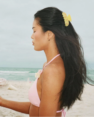 Emi Jay Sweetheart Hair Clip in Citrus Baby Bloom. Model is wearing the hair clip on the beach. 