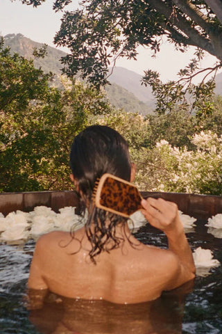 Emi Jay Bamboo Paddle Brush with glossy tortoise shell top and natural bamboo handle, featuring wide paddle design and rounded bristles for gentle detangling