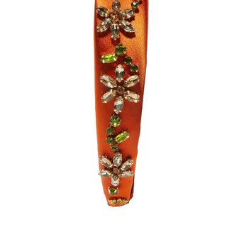 Close-up of the Lele Sadoughi Sienna Meadow Alice Headband, showing detailed crystal flower accents and textured floral patterns on the fabric.