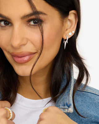 Close-up of model wearing silver Melinda Maria Baby Gabriella Pavé Triple Spike Earrings with layered studs