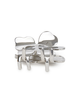 Lele Sadoughi Silver Lily Claw Clip on a white background, shaped like a blooming flower with smooth silver petals.