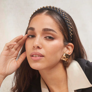 Model wearing Lele Sadoughi Crystal Dorado Burlap Bessette Headband, featuring a sleek, neutral-toned headband with sparkling crystal details on natural burlap fabric.