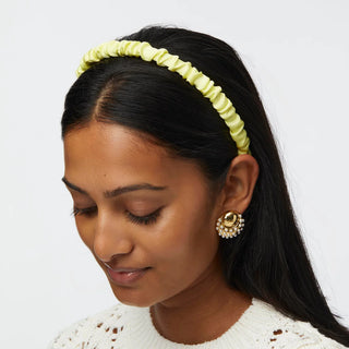 Model wearing Lele Sadoughi Prickly Pear Jessie Silk Headband, featuring a colorful cactus-inspired print on soft, twisted silk fabric.