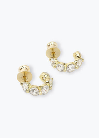 Delicate gold huggie hoops with five prong-set diamondette stones per earring