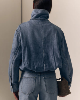 Le Jean Bubble Jacket. Model is turned around and is wearing the jacket. 