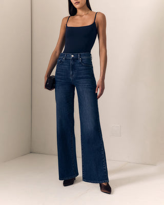 Le Jean Column Jean. Model is posing in the jeans in front of a white background. 