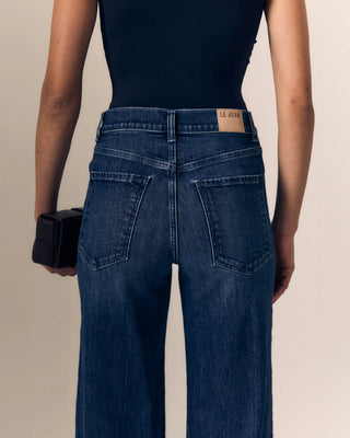 Le Jean Column Jean. Model is turned around and posing in jeans. 