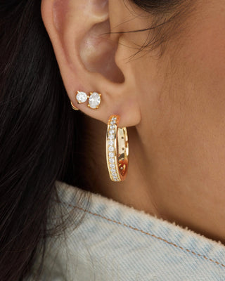 Melinda Maria Ashley Infinity Reversible Hoops 1". Product is shown up close on model.