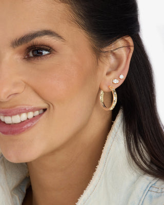 Melinda Maria Ashley Infinity Reversible Hoops 1". Model is wearing product.