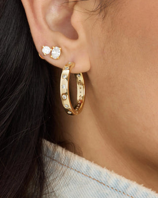 Melinda Maria Ashley Infinity Reversible Hoops 1". Model is wearing product and it is shot up close. 