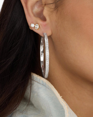 Melinda Maria Ashley Infinity Reversible Hoops 2". Product is shot up close on the model. 
