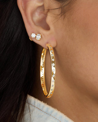 Melinda Maria Ashley Infinity Reversible Hoops 2". Model is wearing product shot up close. 
