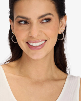 Melinda Maria Ashley Reversible Hoops 1". Model is wearing product. 