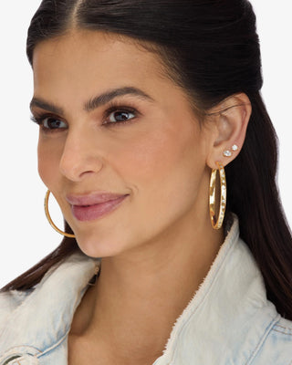 Melinda Maria Ashley Reversible Hoops 2". Model is wearing product shot on white background. 