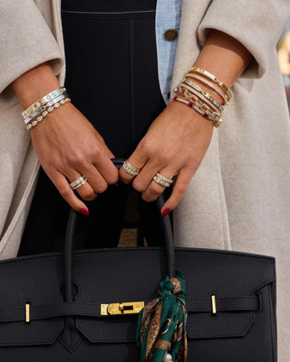 Melinda Maria Ashley Venice Ring. Model is wearing the product and is holding a bag.