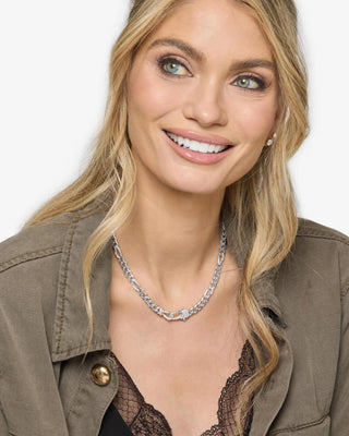 Melinda Maria Knot Figaro Chain Necklace. Model is wearing the product. 
