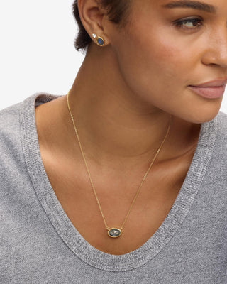 Melinda Maria She's A Boss Gold Labradorite Pendant Necklace. Model is wearing necklace. 