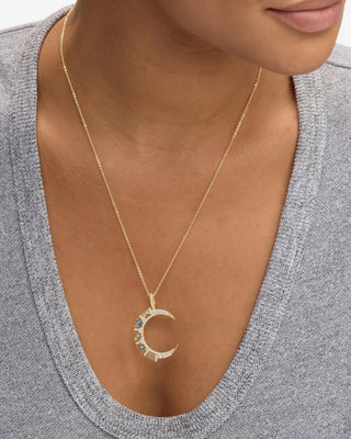 Melinda Maria She's An Icon Gold Labradorite Moon Necklace. Model is wearing the necklace. 