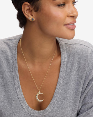 Melinda Maria She's An Icon Gold Labradorite Moon Necklace. Model is wearing the necklace. 