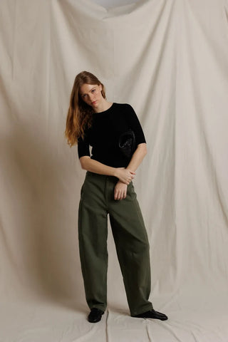 Perfect White Tee Amelia Short Sleeve Luxe Rib True Black. Model is posing in front of a white background wearing the product. 