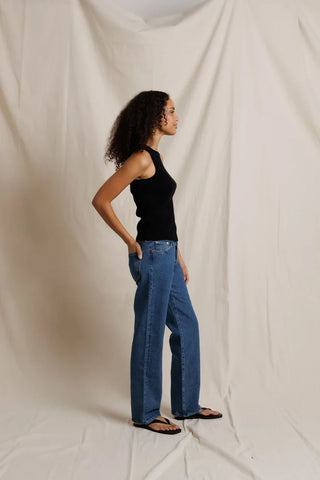 Perfect White Tee Daphne Structured Rib High Neck Tank True Black. Model is wearing the top and is turned to the side. Image is being shot on white background. 