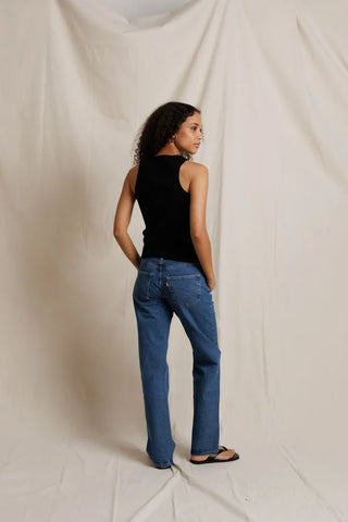 Perfect White Tee Daphne Structured Rib High Neck Tank True Black. Model is wearing the top and has her back to the camera. Image is shot on white background.