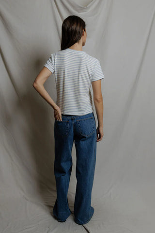 Perfect White Tee Elliot Brushed Sweater Strip V Neck Tee Pacific Stripe. Model has her back to the camera and is wearing the product. 
