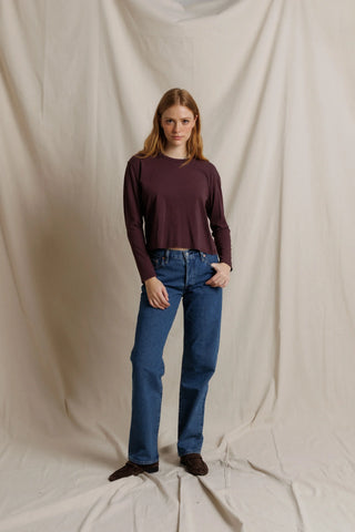 Perfect White Tee Harley Long Sleeve Crispy Cotton Boxy Tee Cherry Lacquer. Model is posing in front of white background.