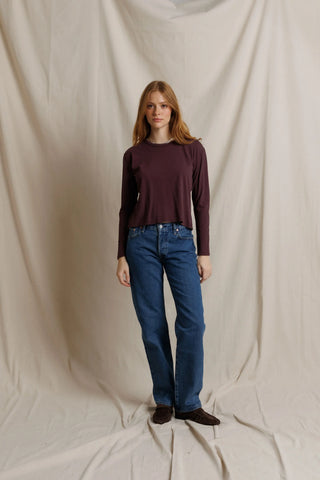 Perfect White Tee Harley Long Sleeve Crispy Cotton Boxy Tee Cherry Lacquer. Model is posing in front of white background.