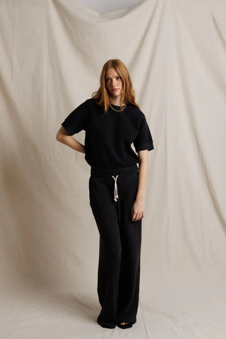 Perfect White Tee Kennedy Vintage Black. Model is posing in front of a white background in the product. 