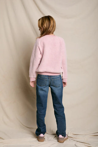 Model has her back facing the camera and the image is shot on a white background. 