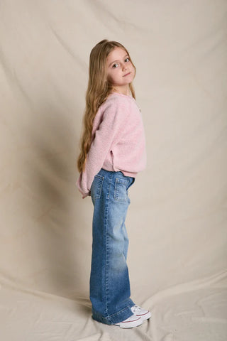 Model is halfway towards the camera and is wearing the product. Image is shot on white background.