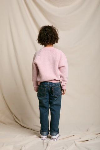 Model has their back to the camera and image is shot on white background. 