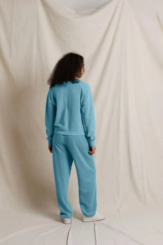 Perfect White Tee Zuri Ziggy Reverse Fleece V-Neck Sweatshirt Milky Blue. Model is wearing product and posing in front of white background.