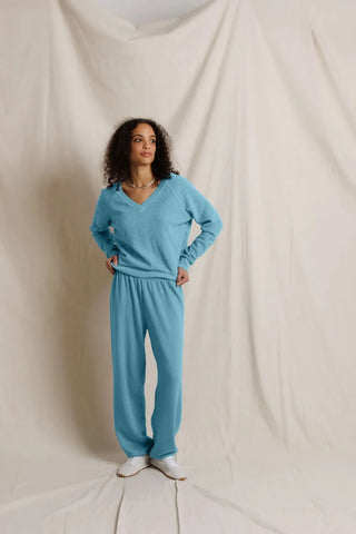 Perfect White Tee Zuri Ziggy Reverse Fleece V-Neck Sweatshirt Milky Blue. Model is wearing product and posing in front of white background.