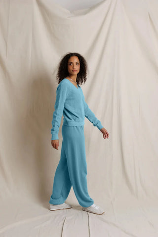 Perfect White Tee Zuri Ziggy Reverse Fleece V-Neck Sweatshirt Milky Blue. Model is wearing product and posing in front of white background.