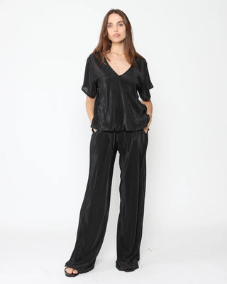 Ripley Rader Black Micropleat Lounge Pant. Model is posing on a white background. 