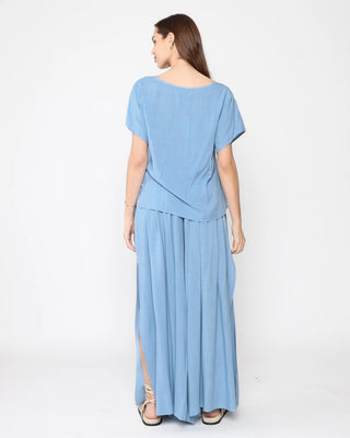Ripley Rader Chambray Linen Everyday V Neck. Model is posing with her back to the camera on a white background in the product. 