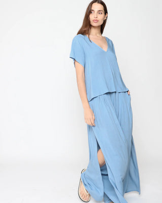 Ripley Rader Chambray Linen Flowy Pant. Model is wearing product posing on a white background.
