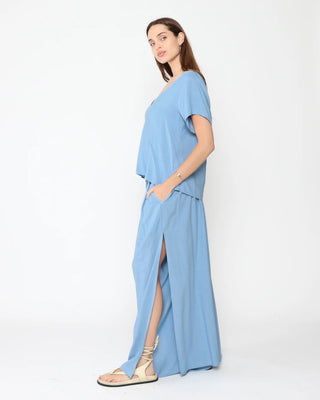 Ripley Rader Chambray Linen Flowy Pant. Model is wearing product posing on a white background.
