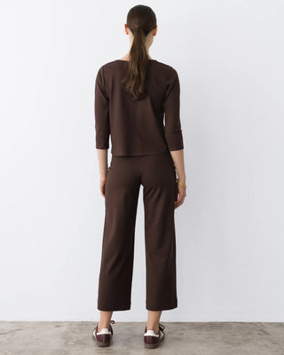 Ripley Rader Chocolate Ponte Knit 3/4 Sleeve Top. Model is turned around and posing in front of a white background.