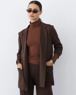 Ripley Rader Chocolate Ponte Knit Oversized Blazer. Model is posing in jacket in front of white background. 