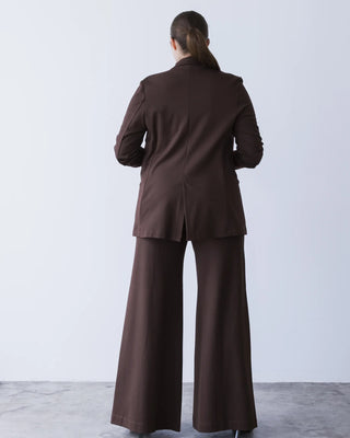 Ripley Rader Chocolate Ponte Knit Oversized Blazer. Model is turned around and posing in front of a white background. 