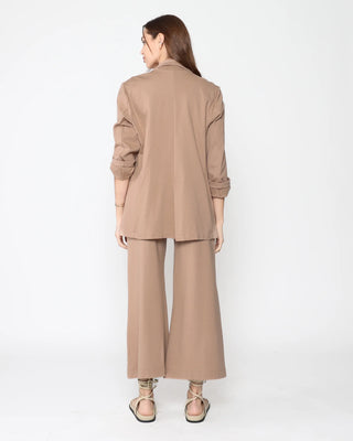 Ripley Rader Khaki Ponte Knit Oversized Blazer. Model is wearing product turned around shot on a white background. 